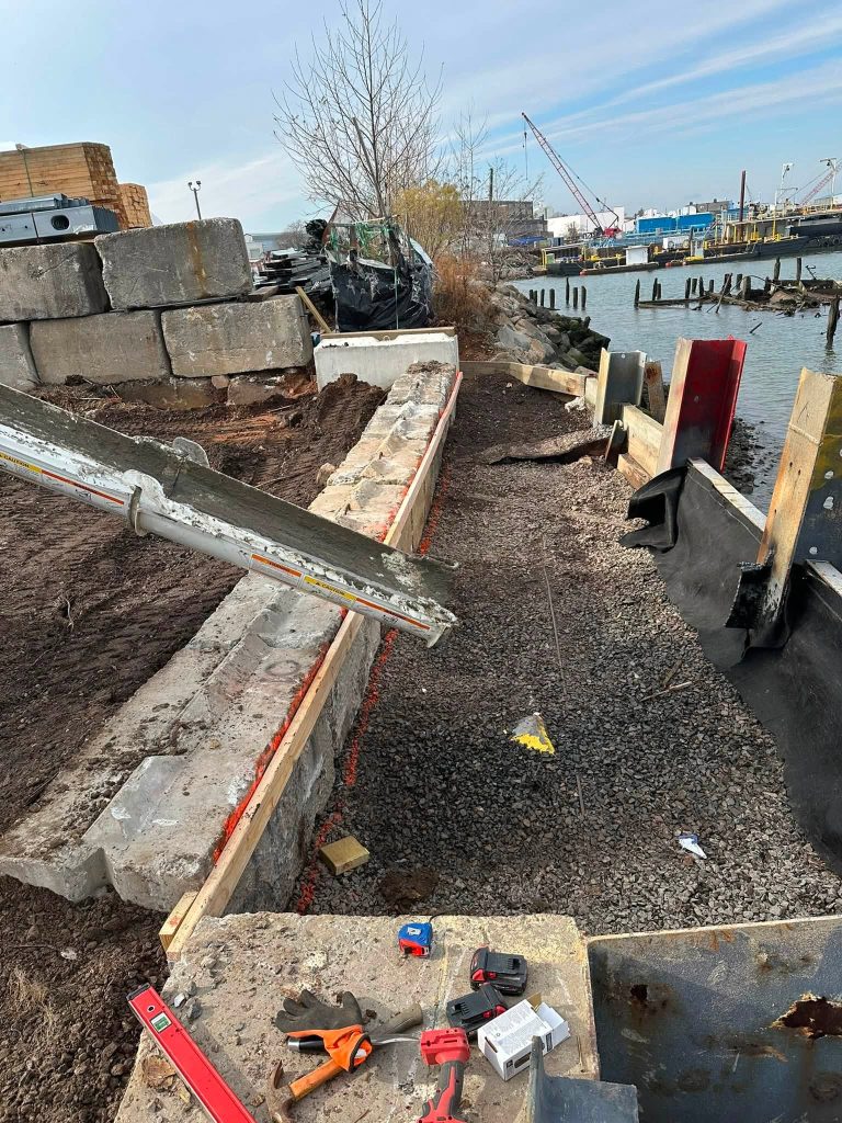 Concrete blocks and forms being set during bulkhead reconstruction along the Staten Island waterfront